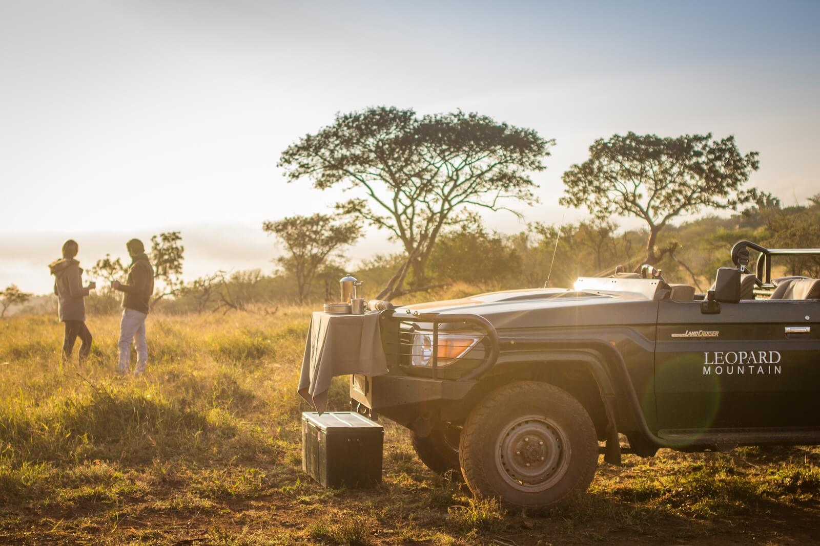 A couple enjoying a private coffee stop in the bush during their luxury Cape Town and safari itinerary.