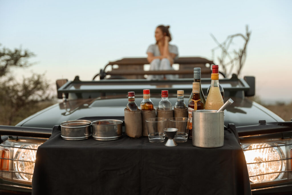 Sundowner drinks set up on a safari vehicle, a highlight of a day in the wild at Leopard Mountain