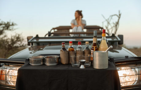 Sundowner drinks table set up on a safari vehicle at Leopard Mountain